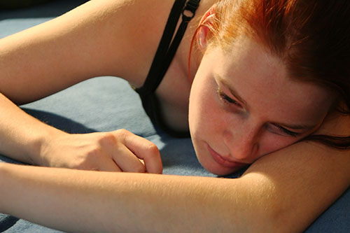 woman laying on floor showing signs of addiction.jpeg