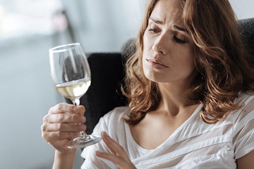 Woman with wine glass who wants to stop drinking but is scared of the alcohol withdrawal timeline